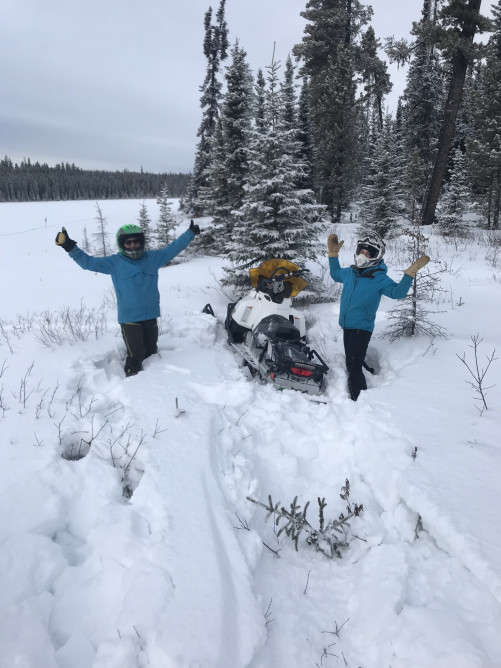 Two reseachers with their snowmobile near the Kakwa camp. Photo credit: Suzanne Stevenson
