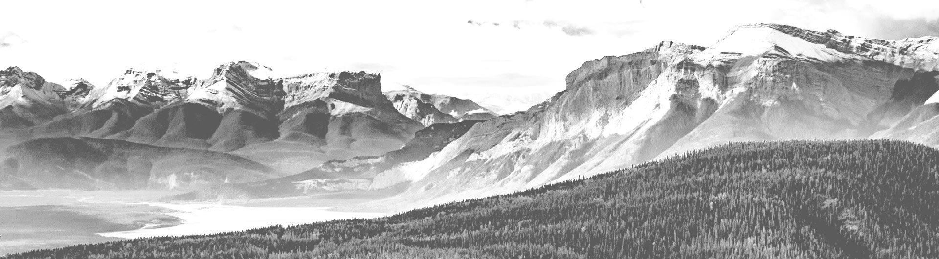 black and white photo of mountains lake hills trees