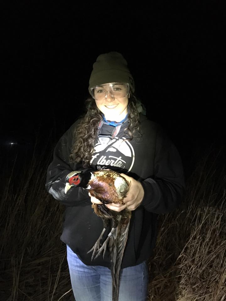 suzanne holding a bird at night