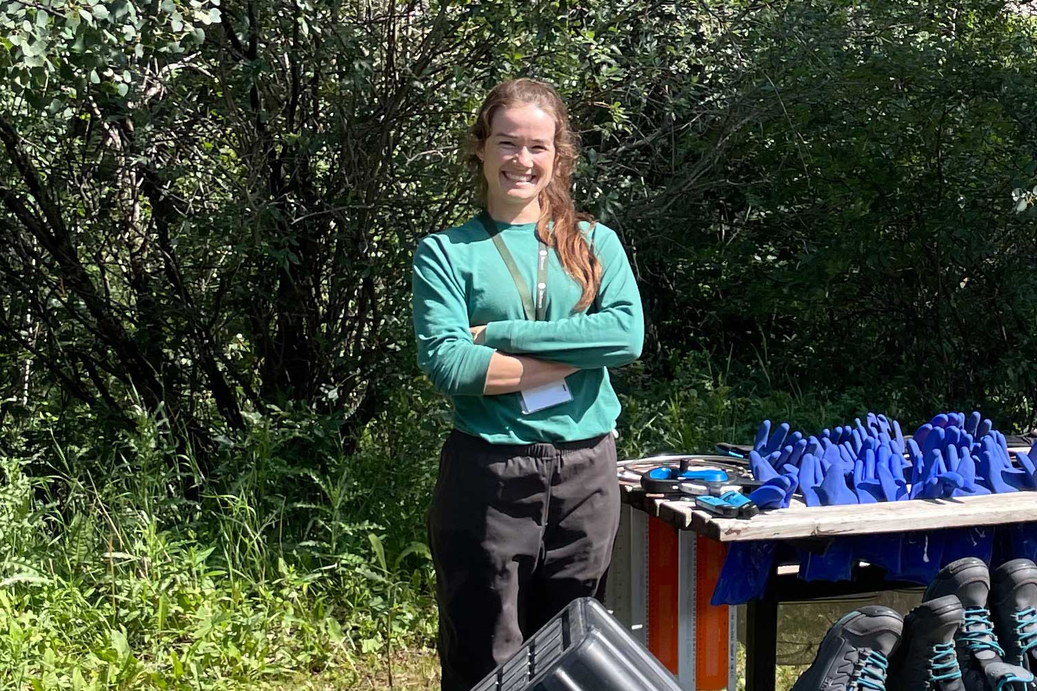 scientist standing by gear at a picnic table