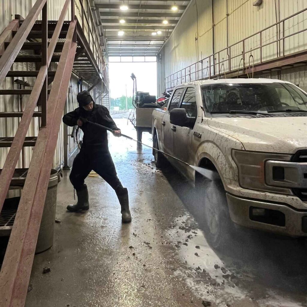 darko gojsic cleaning a muddy pickup truck at a manual car wash
